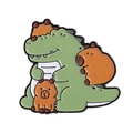 Cute cartoon enamel pin featuring a green dinosaur and orange capybaras with a metal finish - Stacking Capybara Crocodile (QHXZ4083)