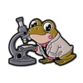 Enamel pin featuring a cartoon frog scientist using a microscope on white background - Microscope Frog Style (QHXZ4241)