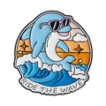 Blue dolphin enamel pin with sunglasses and Ride The Wave slogan on a sunset background - Ride The Wave Style (QHXZ4982)