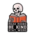 Skull reading enamel pin featuring Read Books Be Kind Stay Weird text in vibrant orange - Skull Reading Book Style (QHXZ5379)