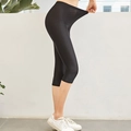 Women's black high-stretch capri leggings with elastic waistband showing flexibility - L / Capri Pants / Black