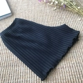 Black ribbed safety shorts with elastic waist and ruffled edges on straw mat - M / Black