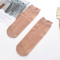 Pair of thin nude velvet short socks for women with fine ribbing on a white background - Coffee