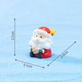 Miniature sitting Santa Claus resin ornament holding a pink heart for Christmas decor - No. 16 Santa Holding Gift