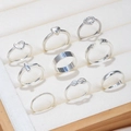 9-piece set of silver rings featuring heart, cross, and infinity designs in a display box - Silver Heart Cross Style