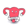 Pink cartoon uterus enamel pin featuring a smiling face and Cuterus ribbon banner - Cartoon Uterus Style (XZ155)