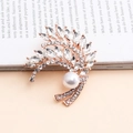 Elegant rose gold feather brooch with marquise crystals and a large white pearl - White