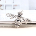 Chic silver bee brooch with sparkling white and black crystals on wings and body - Silver