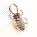 Vintage stag beetle brooch with amber rhinestones on a retro gold alloy base - Champagne