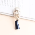 Artistic gold face and black enamel hand brooch on an open book in a modern style - Silver Gray
