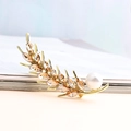 Elegant gold wheat brooch with champagne crystals and a white pearl on a magazine - Champagne Stone (Gold Base)