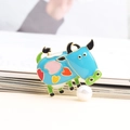 Cute blue cow enamel brooch with colorful heart patterns and pearl accent. - Blue