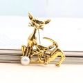 Retro golden cat alloy brooch with white imitation pearl set against a clean background - Gold