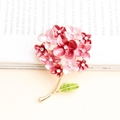 Elegant gold flower brooch featuring pink gradient enamel petals and crystal accents - Watermelon red