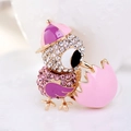 Macro detail of bird hatching brooch with sparkling pink rhinestones and enamel wings - Pink Purple Bird (Style 6)