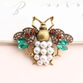 Vintage gold bee brooch with brown crystals and white pearl abdomen on decorative card - Antique Gold + Green