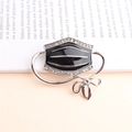 Black enamel mask brooch with sparkling rhinestones and a silver bow detail - Black Mask (5038530716463) / Black