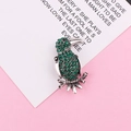 Dettaglio della spilla a pappagallo con strass verdi e occhio di gemma nera su argento - Argento Antico Verde