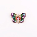 Close-up of butterfly enamel brooch with colorful rhinestones and purple wing detail - Green