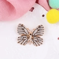 Prachtige vergulde vlinderbroche met fonkelende strass steentjes en zwarte emaille details - Stijl 2