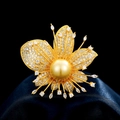Elegant gold flower brooch with large golden pearl and pavé zircon accents on blue silk - Gold