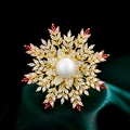Luxury gold snowflake brooch with central pearl and vibrant zircon stones on green silk - Pink