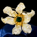 Luxury 3D flower brooch with green zircon center and pavé petals on blue velvet - Gold