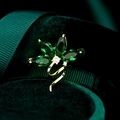 Macro shot of gold orchid brooch with green marquise gems and white zircons - Emerald Green Orchid Brooch (TB752)