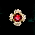 Macro detail of luxury floral brooch with red ruby center and micro-pave cubic zirconia - Red