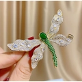 Elegant green dragonfly brooch with sparkling crystals on a golden base and warm silk background - Green Dragonfly Style (TB819)