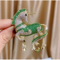 European vintage unicorn brooch with green rhinestones on elegant champagne satin fabric - Tb1192