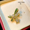 Detailed close-up of emerald green bow brooch with hanging star charm and size marking - Gold Bowknot Star Green Zircon Style (D127)