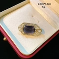 Luxurious purple gemstone brooch with white diamond halo in a red gift box - Purple
