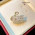 Macro shot of a mini gold swan brooch with crystals, size 2.2cm by 1.9cm and 4g weight - White Crystal Swan Style (D145)