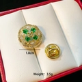 Macro shot of 1.8cm golden brooch with green gems and diamonds on a red border box - Green Gem Round Ring(C210)