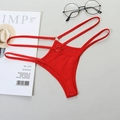Close-up of red thong with hollow straps and metal ring details on a flat background - M / Red