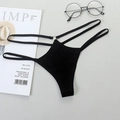 Sexy black thong with double straps and gold metal ring detail on gray background - Black