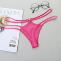 Sexy rose pink thong with thin straps and gold metal ring accents on light background - Magenta