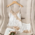 Satin two-piece pajama set with lace trim featuring camisole top and matching shorts - S / White
