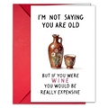 Detail of funny birthday card with red envelope and humorous wine quote for adults - T020401251