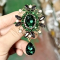 Vintage gold brooch with emerald crystals and teardrop pendant shown in hand - Emerald Green(DLA333-C)