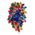 Detailed macro view of crystal brooch with colorful rhinestones and blue center stone - Multicolor (Gold Base)