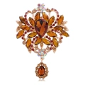 Vintage gold brooch with amber teardrop gemstone and intricate rhinestone floral details - Gold Tone Amber Crystal