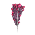 Macro shot of elegant feather brooch with purple pavé crystals and pink teardrop gems - Fuschia