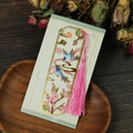 Close-up of hollow metal bookmark with magpie and plum blossom motifs and pink tassel - Magpie Plum Style (T01042523)