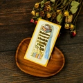 Detailed view of gold metal bookmark with coffee cup design and blue tassel on wood - Between the pages Style (T01042566)