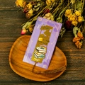 Macro detail of gold metal bookmark with Years Fly By engraving and brown silk tassel - Books and Quill Design (T01042624)