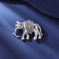 Silver elephant brooch with hollow saddle and sparkling crystals on blue fabric - Hollow Saddle Style / Silver