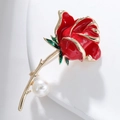 Macro shot of red enamel rose brooch with golden edges, green leaves and a white pearl - Pearl Red Rose (XZ004)