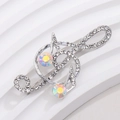 Macro detail of violin musical note brooch with sparkling crystals on white stand - Silver Frame Iridescent Rhinestone Note